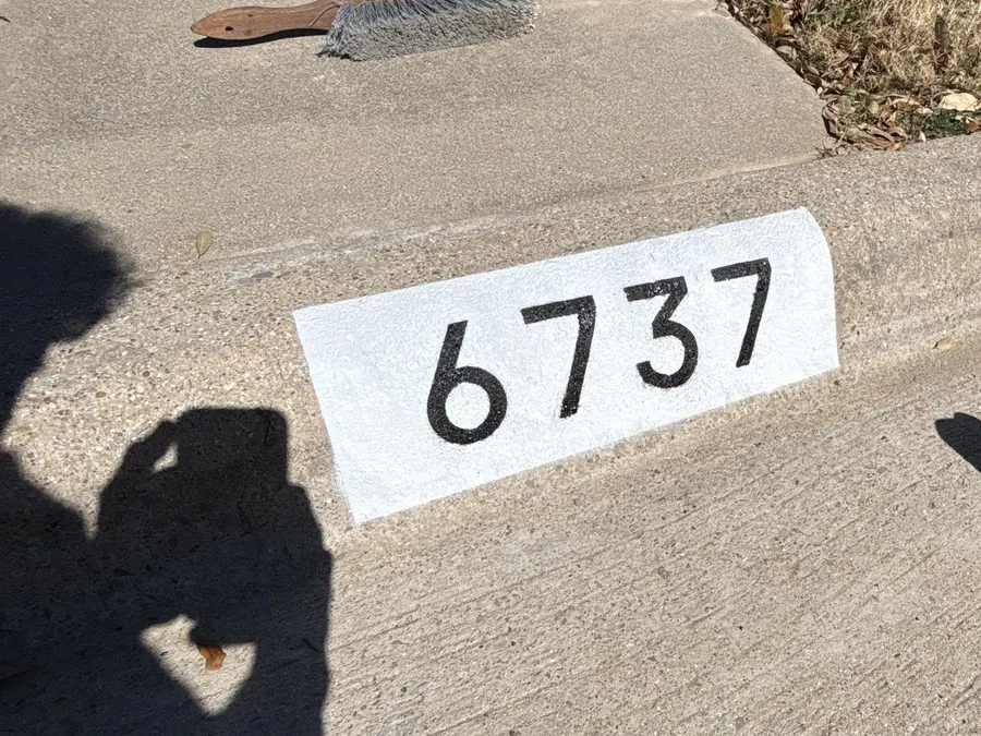 Freshly painted curb address numbers