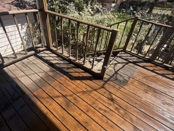 Wood deck mid-clean, half cleaned to show the difference