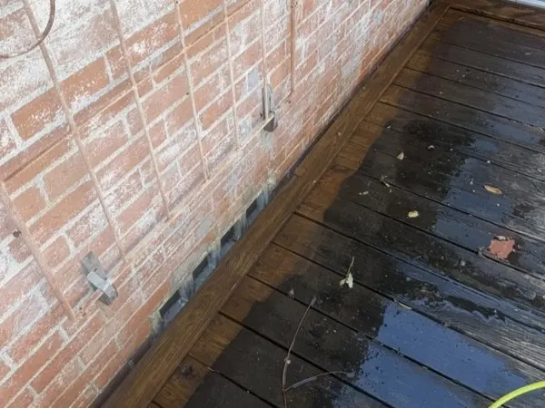 Deck boards mid-clean, half cleaned to show the difference