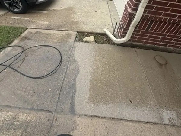 Driveway by the garage, half cleaned to show the difference